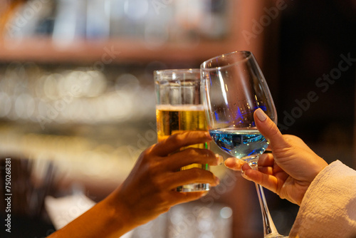 Wallpaper Mural close up glasses of clinking glasses of champagne with lighting. Dinner party with drinking of champagne. hands holding clear glass with alcohol in yellow shine reflect. Torontodigital.ca