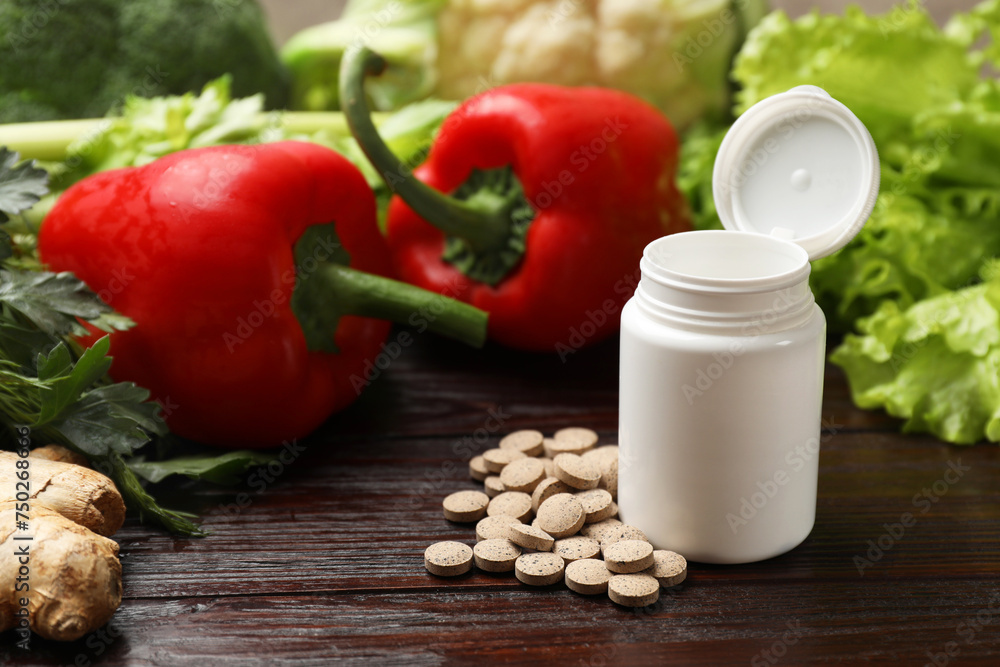Dietary supplements. Plastic bottle, pills and food products on wooden table Dietary supplements. Plastic bottle, pills and food products on wooden table