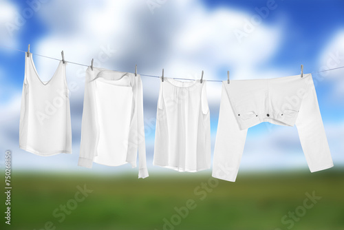 Different clothes drying on washing line outdoors