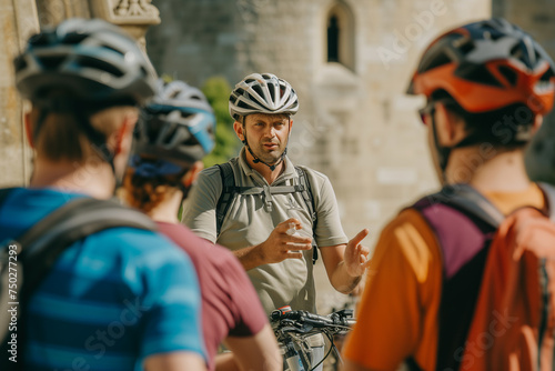 Wallpaper Mural cycle-tour guide, helmet on, gesturing towards an iconic building, surrounded by a group of cyclists with their bikes Torontodigital.ca