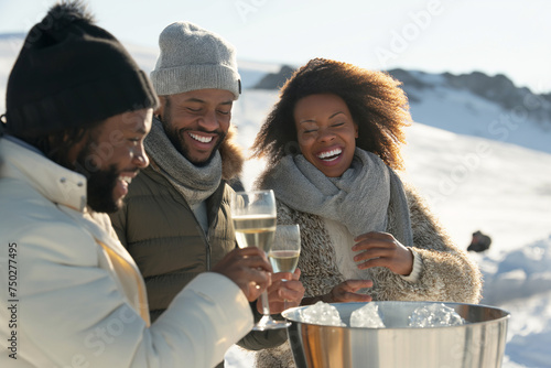 At the peak of a majestic ski mountain, a racially diverse group enjoys a luxury champagne breakfast