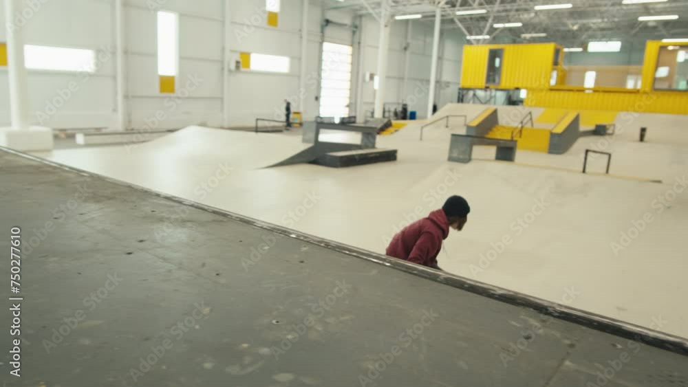 Young skater performing trick, skateboarder training in skatepark, making tricks, slides and flips, jump over the gap, professional extreme sport athlete ride on skateboard. Young skater performing trick, skateboarder training in skatepark, making tricks, slides and flips, jump over the gap, professional extreme sport athlete ride on skateboard.