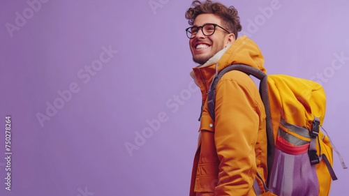 Portrait happy man at the studio against purple background. Traveling and tourism concept. People with backpack for trip at the summer.