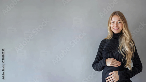 Blonde pregnant woman with pregnancy belly, in soft black clothes © pariketan
