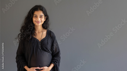 Indian pregnant woman with pregnancy belly, in soft black clothes photo