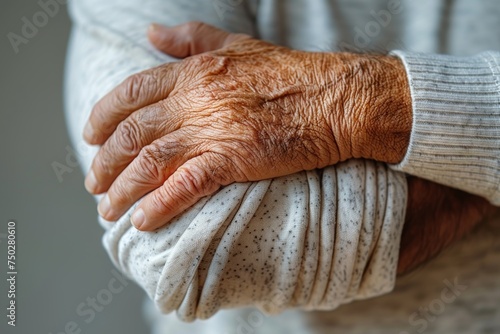 The image captures the intricate details and texture of an elderly person's hands, conveying a sense of age, history, and life lived photo