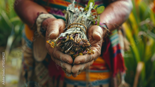 A shaman holding a bundle of sage traditionally used in South American cultures for spiritual cleansing and purification. photo