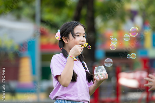 Girls in the park with blowing air bubble  Surrounded by greenery and nature