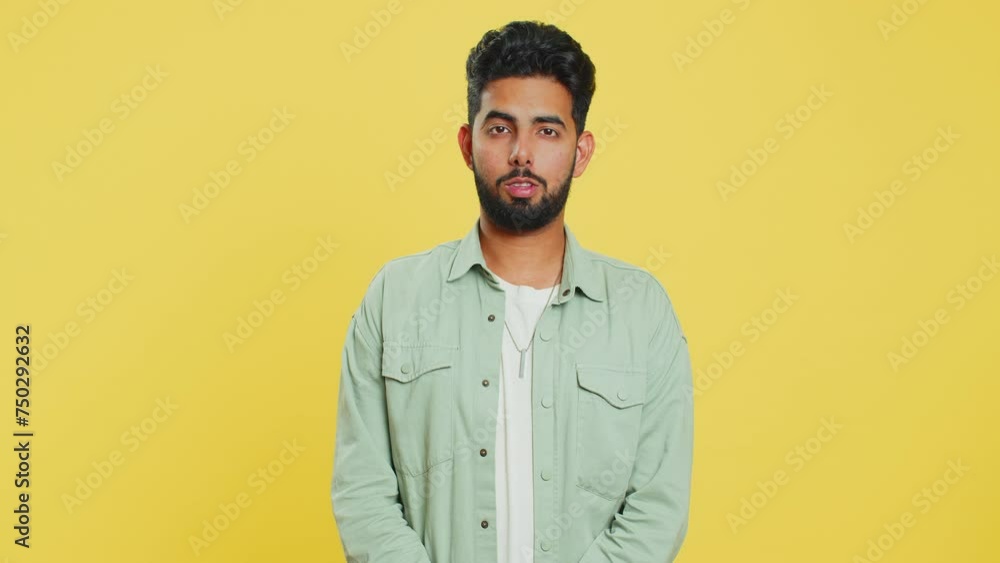Displeased upset Indian man reacting to unpleasant awful idea, dissatisfied with bad quality, wave hand, shake head No, dismiss idea, don't like proposal. Arabian guy isolated on yellow background Displeased upset Indian man reacting to unpleasant awful idea, dissatisfied with bad quality, wave hand, shake head No, dismiss idea, don't like proposal. Arabian guy isolated on yellow background