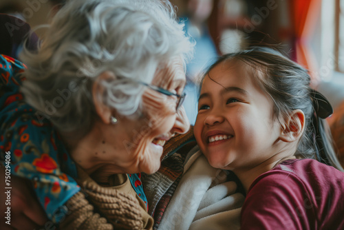 A touching moment as an elderly woman and her young granddaughter share a laugh together, illustrating a loving family bond