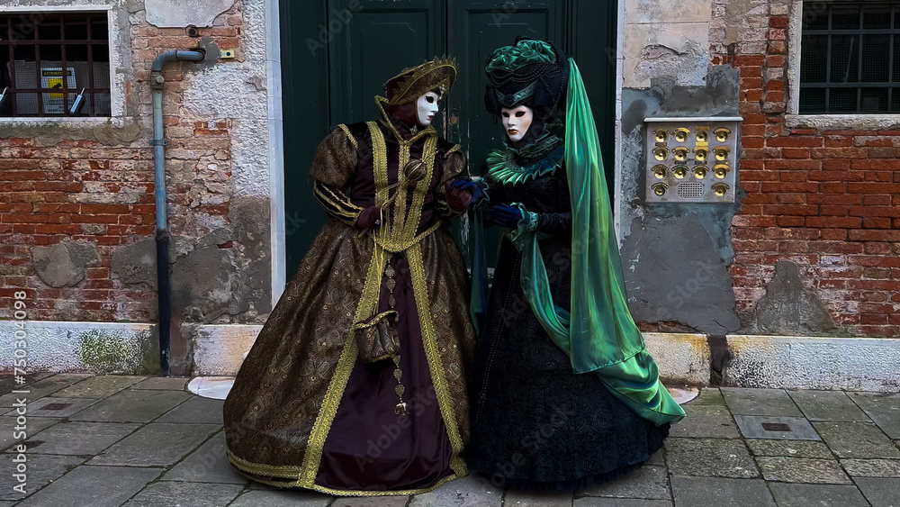 Venice Carnival. People in Venetian carnival masks and costumes on streets of Venice, Italy, Europe February 10, 2024 Venice Carnival. People in Venetian carnival masks and costumes on streets of Venice, Italy, Europe February 10, 2024