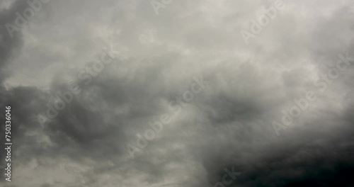 Timelapse dark storm clouds dramatic black sky background. Dark clouds before thunderstorm coming. Meteorology danger windstorm climate. Dark cloudscape storm disaster timelapse gloomy gray sky. photo