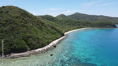 Aerial panoramic view of volcanic island of Yasawa in the Pacific Ocean. Green peaks and sun-drenched white sand beach with turquoise water. Fiji, South Pacific Ocean photo