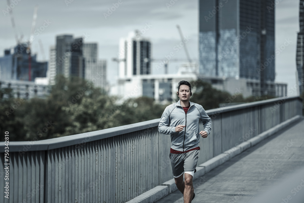 A man running up on footbridge in the city center park for cardio workout.  Health and Lifestyle in big city life concept. - obrazy, fototapety, plakaty 