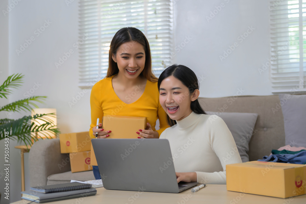 Happy successful team of Asian start up business packaging their products, selling the cloth online to customers. Happy successful team of Asian start up business packaging their products, selling the cloth online to customers.