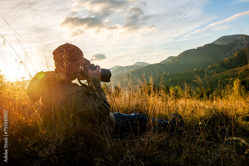 Professional nature photographer in mountain with sunset photo