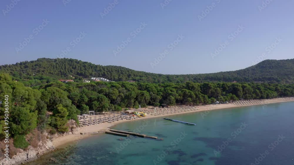 Aerial: Koukounaries beach in Skiathos island, Greece on a sunny day Aerial: Koukounaries beach in Skiathos island, Greece on a sunny day