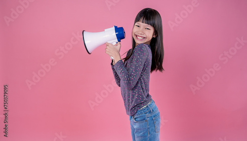 Portrait of young fun smart happy little asian long hair girl isolated on pink studio shot. Education for elementary kindergarten, little girl hold megaphone loudspeaker back to school concept.