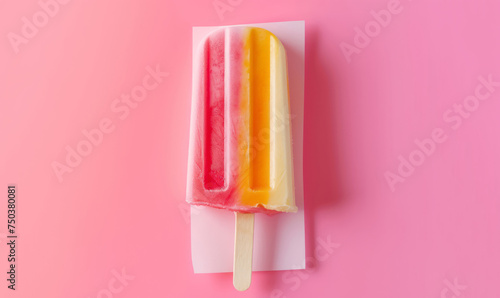 The white paper serves as the backdrop for a colorful ice pop in light pink and orange.