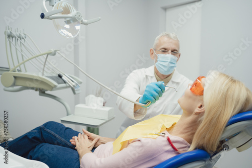 Dental doctor treating a female patient in hospital.