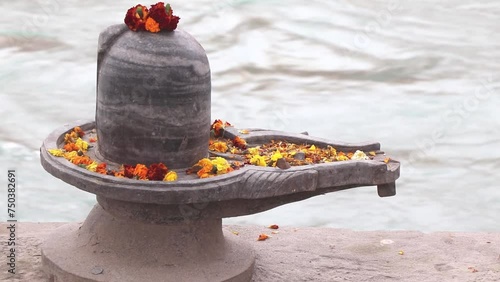 Shiva lingam on the bank of river ganga.In Hinduism, shiva lingam is a highly sacred stone to devotees. photo