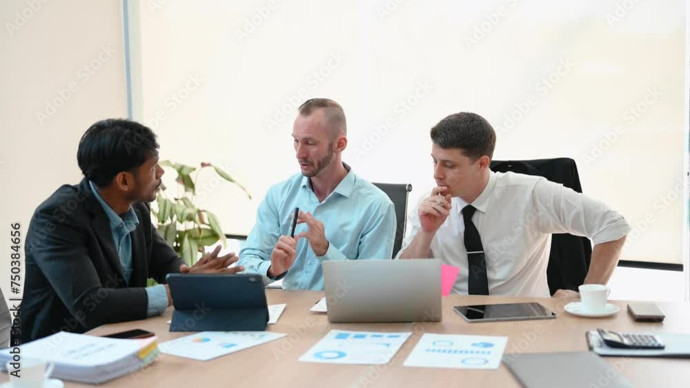 Happy businesspeople while collaborating on a new project. Group of diverse businesspeople using a laptop and tablet in office.. Happy businesspeople while collaborating on a new project. Group of diverse businesspeople using a laptop and tablet in office..
