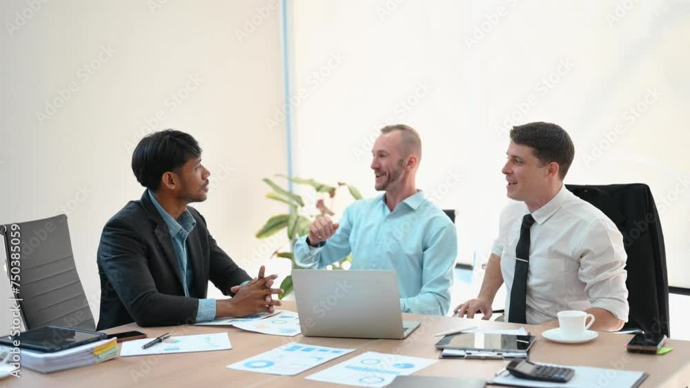 Happy businesspeople while collaborating on a new project. Group of diverse businesspeople using a laptop and tablet in office.. Happy businesspeople while collaborating on a new project. Group of diverse businesspeople using a laptop and tablet in office..