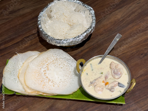 Noolappam Idiyappam rice noodles appam popular traditional steam cooked Kerala breakfast dish hot and spicy coconut chicken curry houseboat Alleppey India. South Indian food. noolputtu Sri lankan