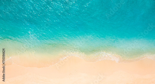 Summer seascape beautiful waves, blue sea water in sunny day. Top view from drone. Relax sea aerial view amazing tropical nature background. Tranquil bright sea waves splashing beach sand sunset light © icemanphotos