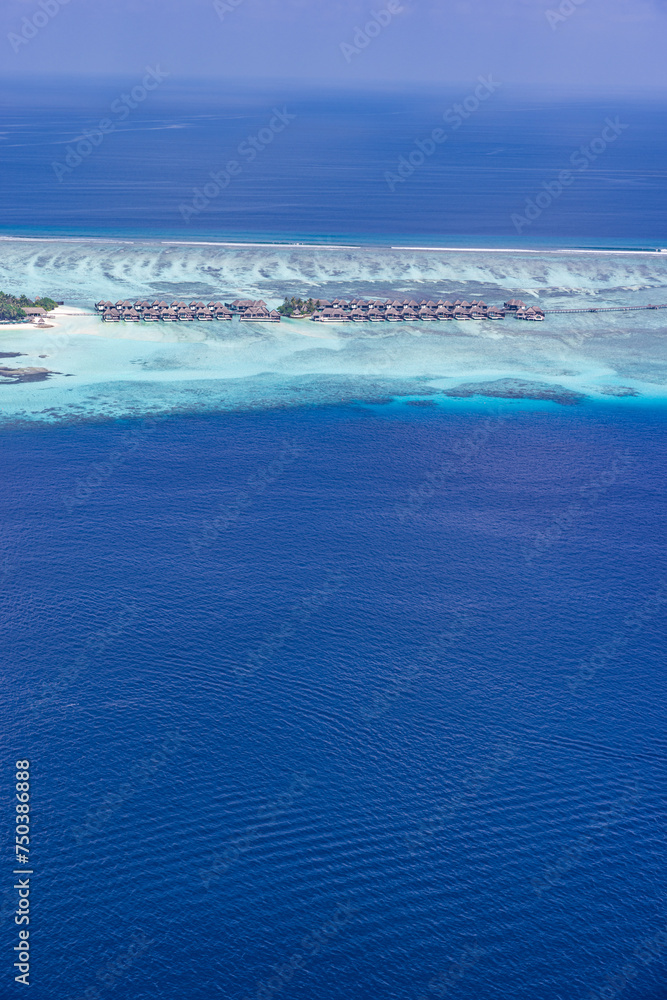 Maldives paradise island resort. Tropical aerial landscape, seascape yacht with water bungalows villas with amazing sea beach. Exotic tourism destination, summer vacation background. Aerial travel