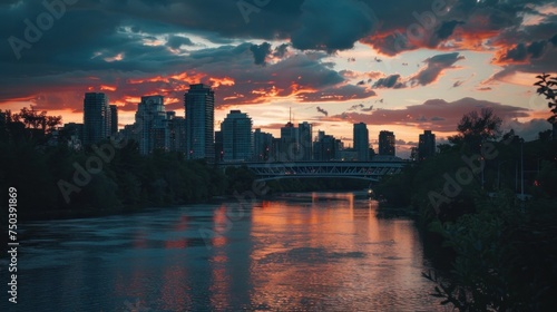 Evening cityscape with illuminated buildings reflecting in river. Urban architecture at sunset with vibrant sky. City infrastructure and modern metropolitan landscape. Urban develo photo