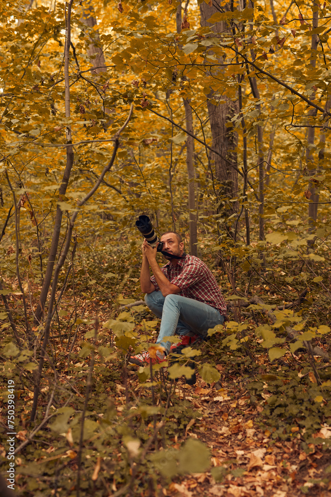 Man using binoculars and camera for bird and animal watching in nature. Man using binoculars and camera for bird and animal watching in nature.