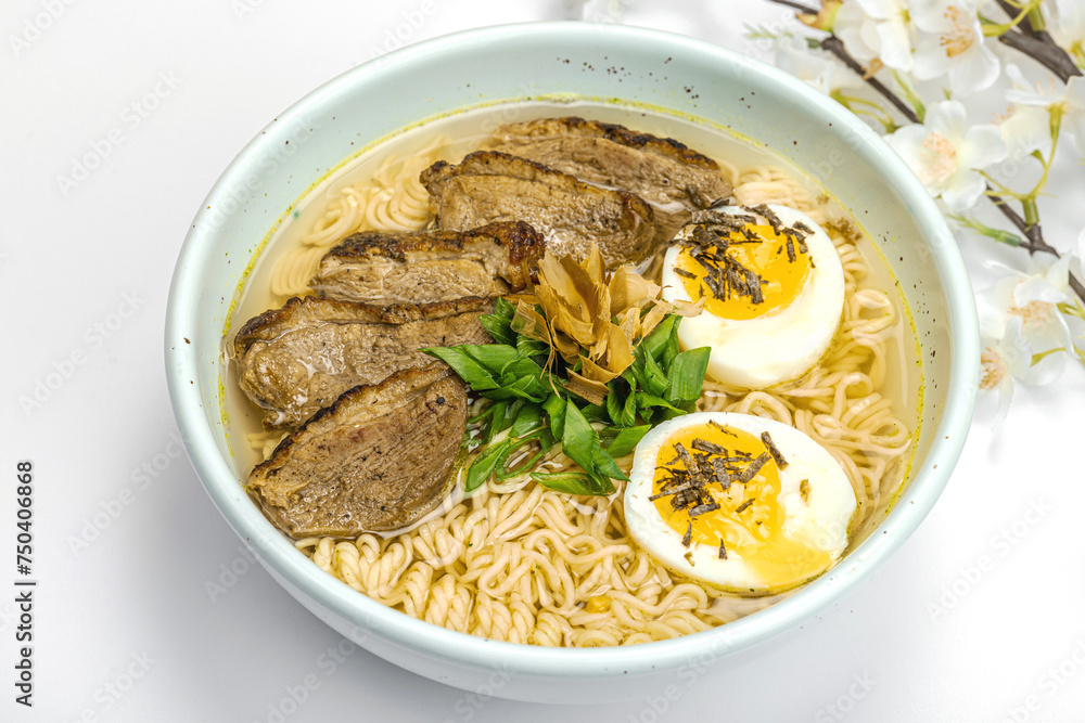 Japanese noodles Ramen with broth. Hot dish, duck, egg, greens. White background, cherry flowers Japanese noodles Ramen with broth. Hot dish, duck, egg, greens. White background, cherry flowers