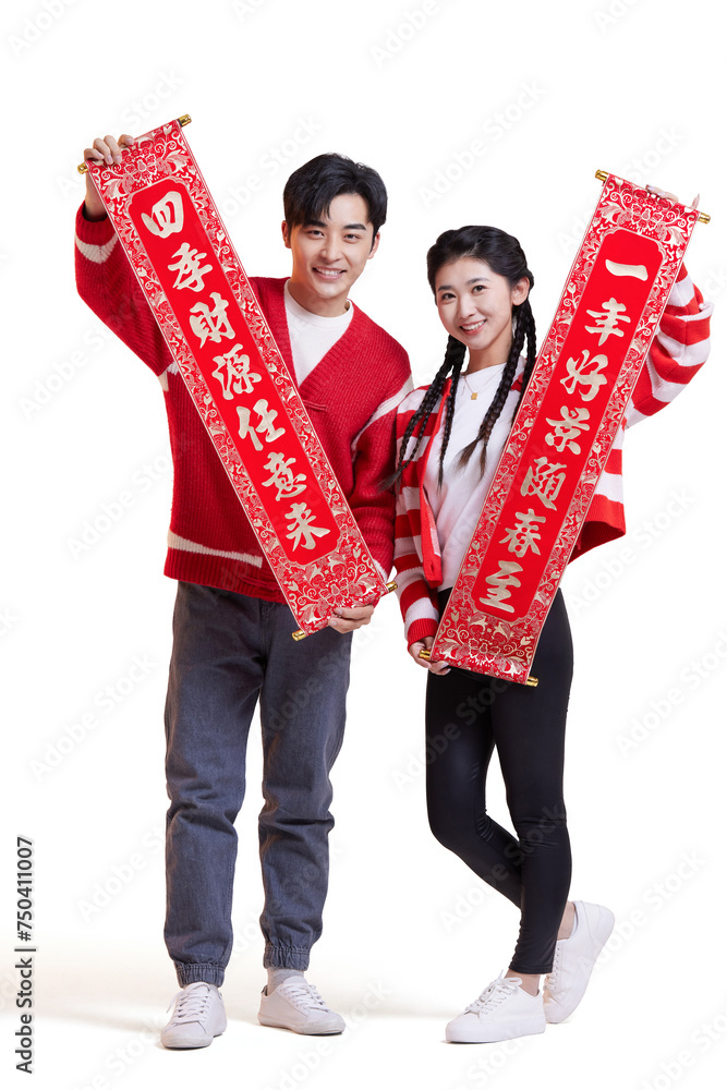 Happy young couple with couplets celebrating Chinese new year Happy young couple with couplets celebrating Chinese new year