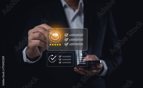 Customer satisfaction rating five stars. Businessman Rating Service on Virtual Screen. Businessman holding a phone and giving a five-star rating on a futuristic virtual interface. Business concept.