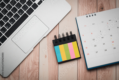 Workspace Organization with Laptop, Index Flags, Calendar on Wooden Desk