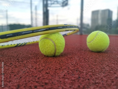 Tennis racket and ball on a hard tennis court © Angelov