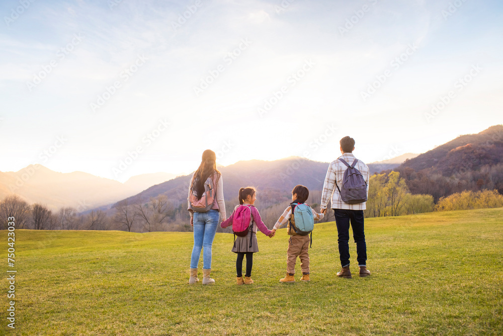 Cheerful young family enjoying the beautiful natural scenery Cheerful young family enjoying the beautiful natural scenery