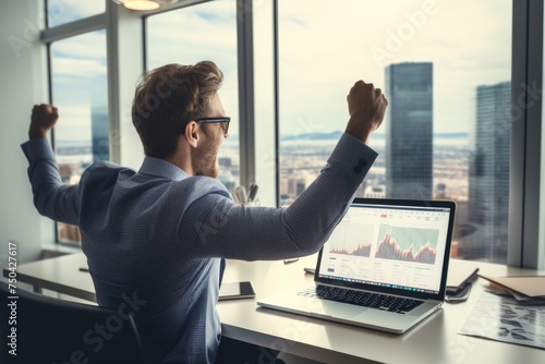 Successful businessman celebrating in an office with city view