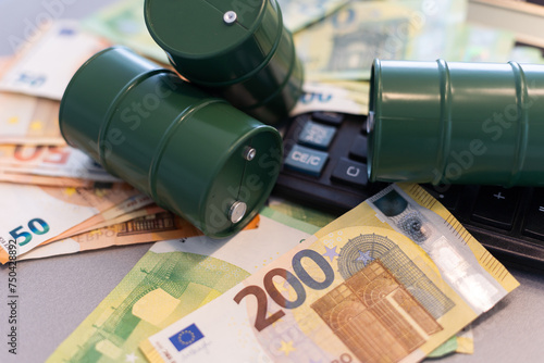 oil barrel with money, euro banknotes closeup photo