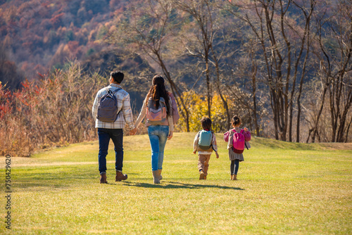 Happy young family hiking outdoors photo