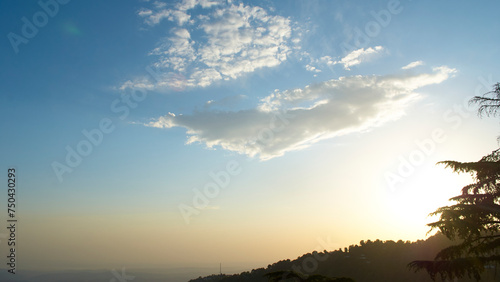 A vast landscape with clear skies  clouds  and snowy mountains.