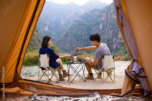 Happy young couple camping outdoors photo