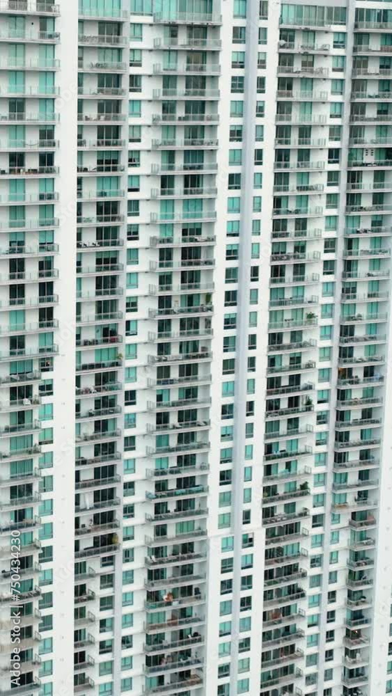 Facade of high multi-story building with balconies and windows. Skyscraper buildings in downtown district of Miami Brickell. American megapolis. Vertical video. Facade of high multi-story building with balconies and windows. Skyscraper buildings in downtown district of Miami Brickell. American megapolis. Vertical video.