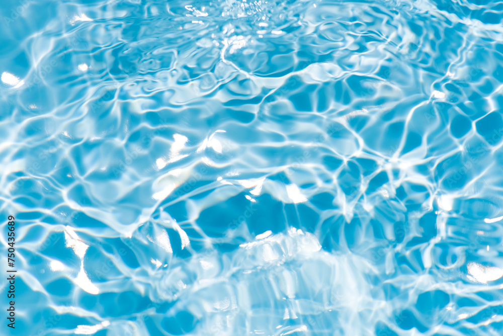 Obraz premium Blue water surface texture with ripples, splashes, and bubbles. Abstract summer banner background Water waves in sunlight with copy space cosmetic moisturizer micellar toner emulsion. Blue water wave
