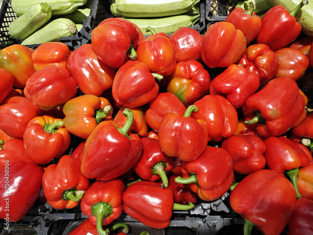 Raw red bell pepper in plastic basket on the shelf