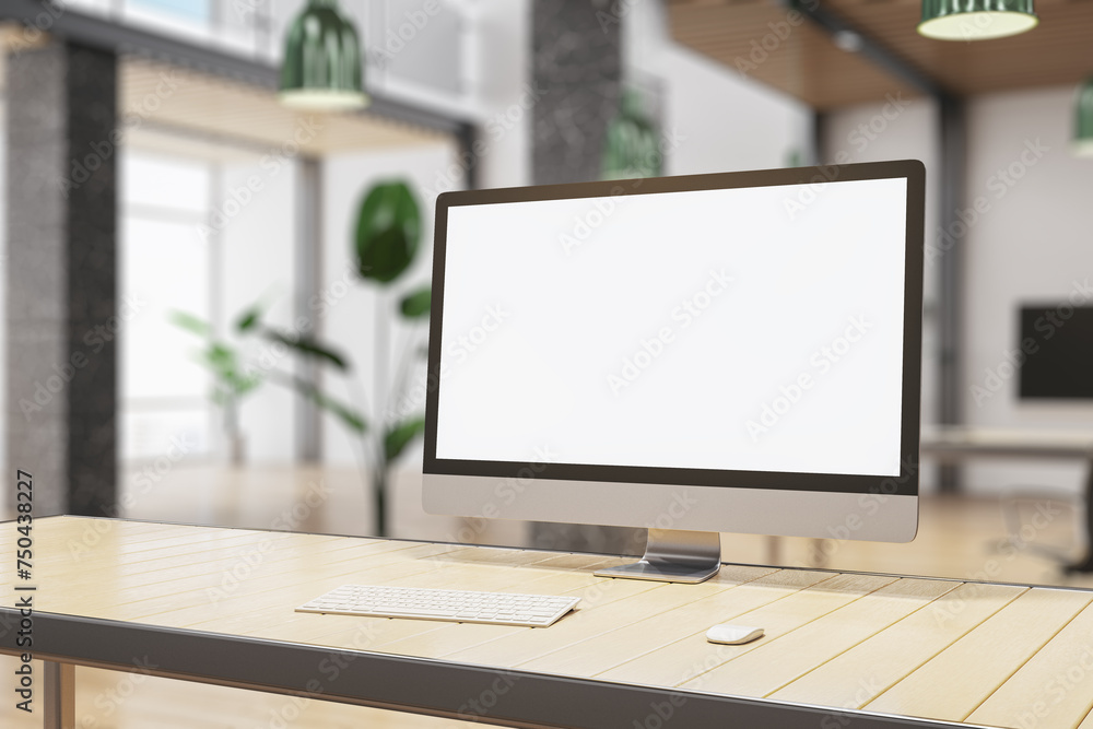Fototapeta premium Creative designer desk top with empty white mock up computer montior, supplies and blurry office interior in the background. 3D Rendering.