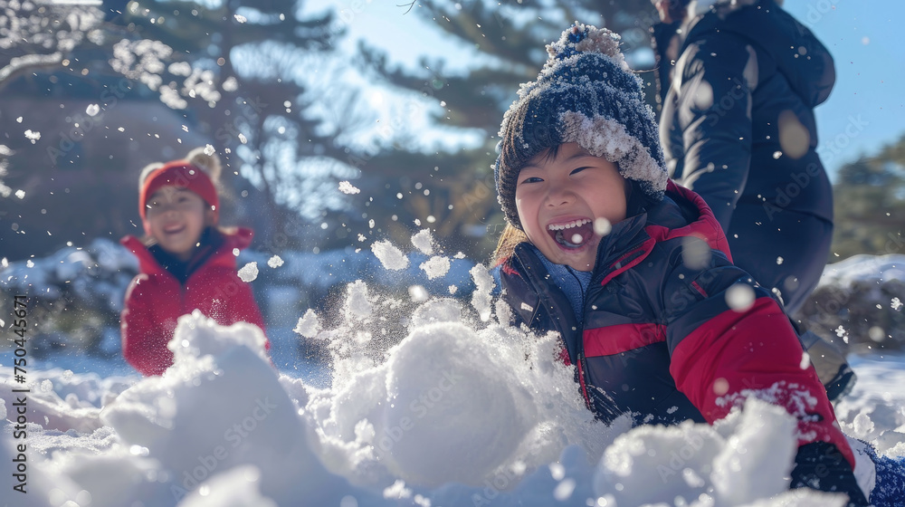Two children, a boy and a girl, are joyfully playing in the snow, building snowmen and having a snowball fight on a winter day