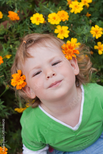 Child in the Garden, Surrounded by Vibrant Yellow Flowers and Lush Greenery