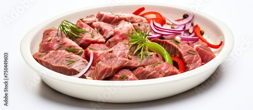 Fresh Raw Beef Meat Slices in a Ceramic Dish with Onions and Peppers for Culinary Delight